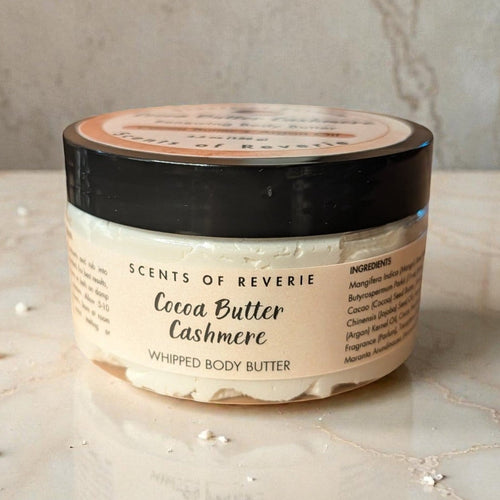 Jar of Scents of Reverie Cocoa Butter Cashmere Whipped Body Butter on a marble surface