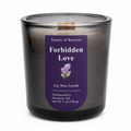A dark gray smoky glass jar candle with a purple label reading 'Forbidden Love' by Scents of Reverie, on a white background.