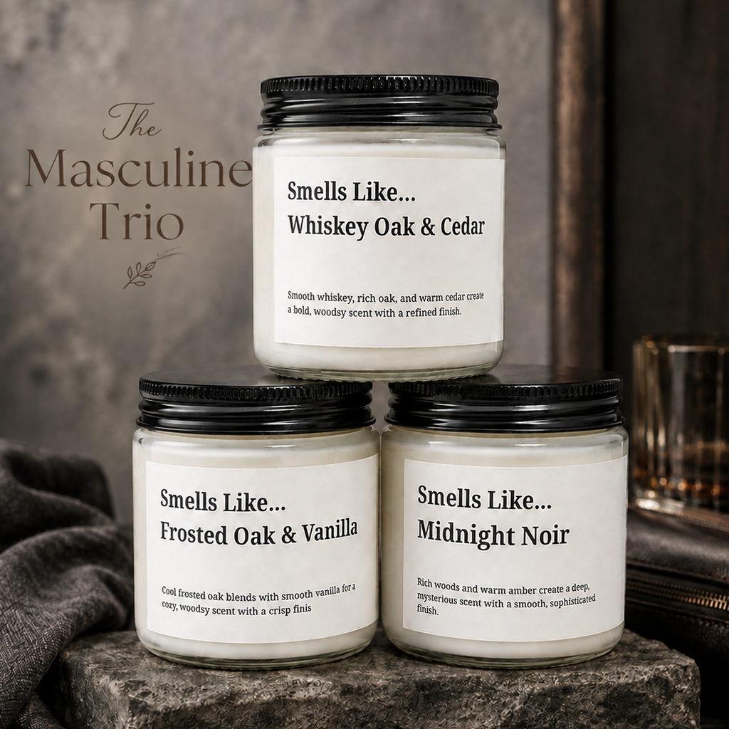Three scented candles in frosted glass jars with black lids are arranged on a rustic wooden surface. The top candle reads 'Smells Like.