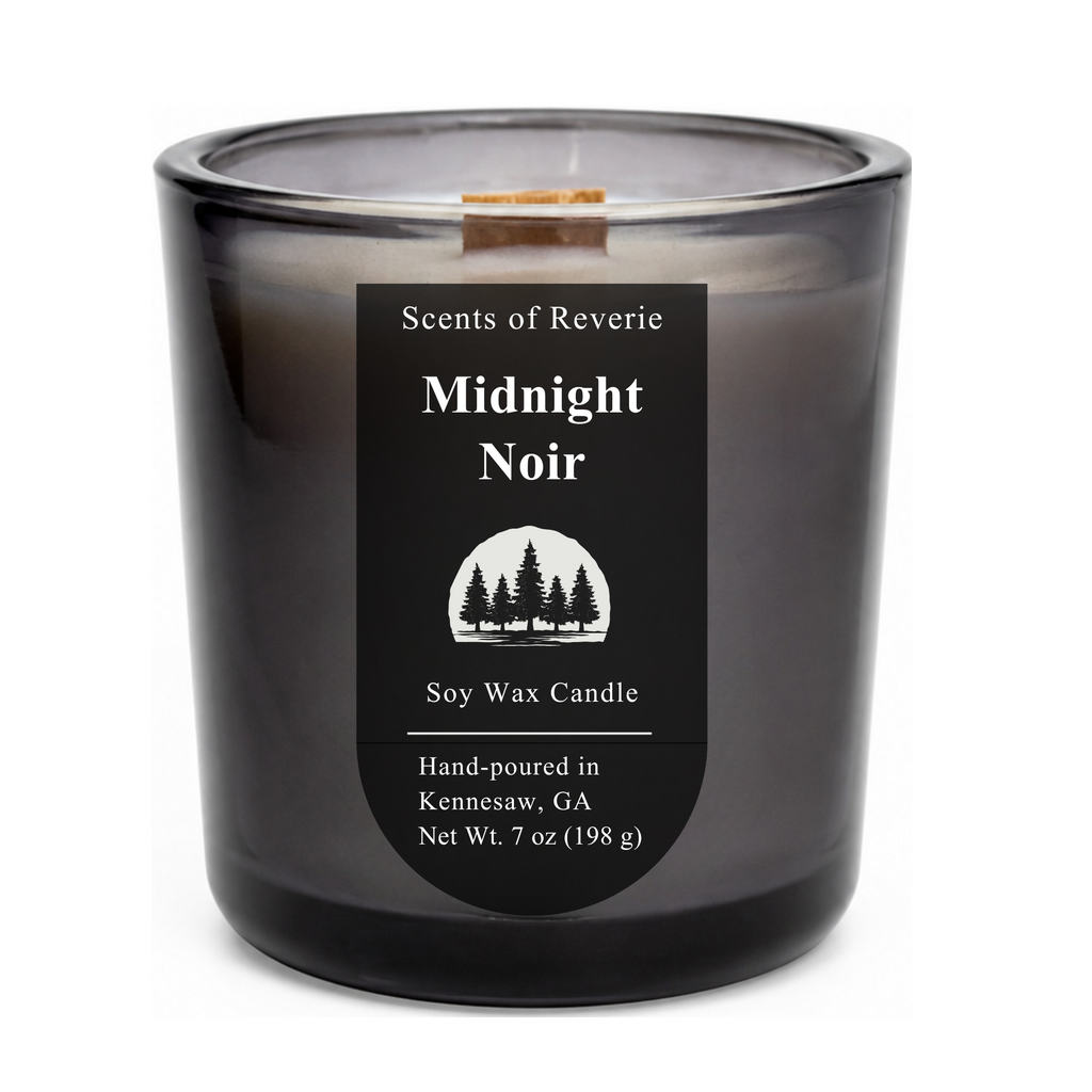 Black candle labeled 'Midnight Noir' by Scents of Reverie on a white background