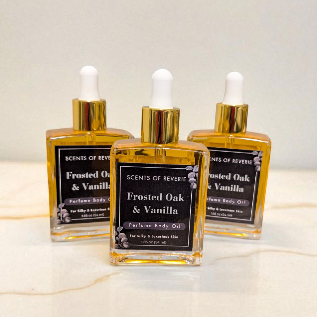 Three bottles of Frosted Oak & Vanilla perfume on a marble surface with a light background