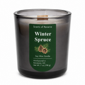 A Scents of Reverie Winter Spruce soy wax candle in a dark gray glass jar with a green label, shown on a white background.