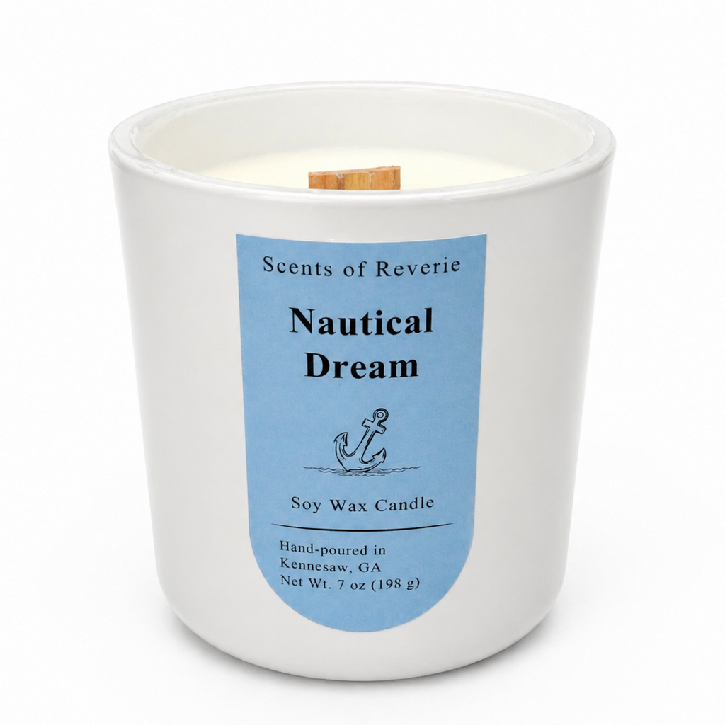 Candle with a blue label titled 'Nautical Dream' by Scents of Reverie on a white background.