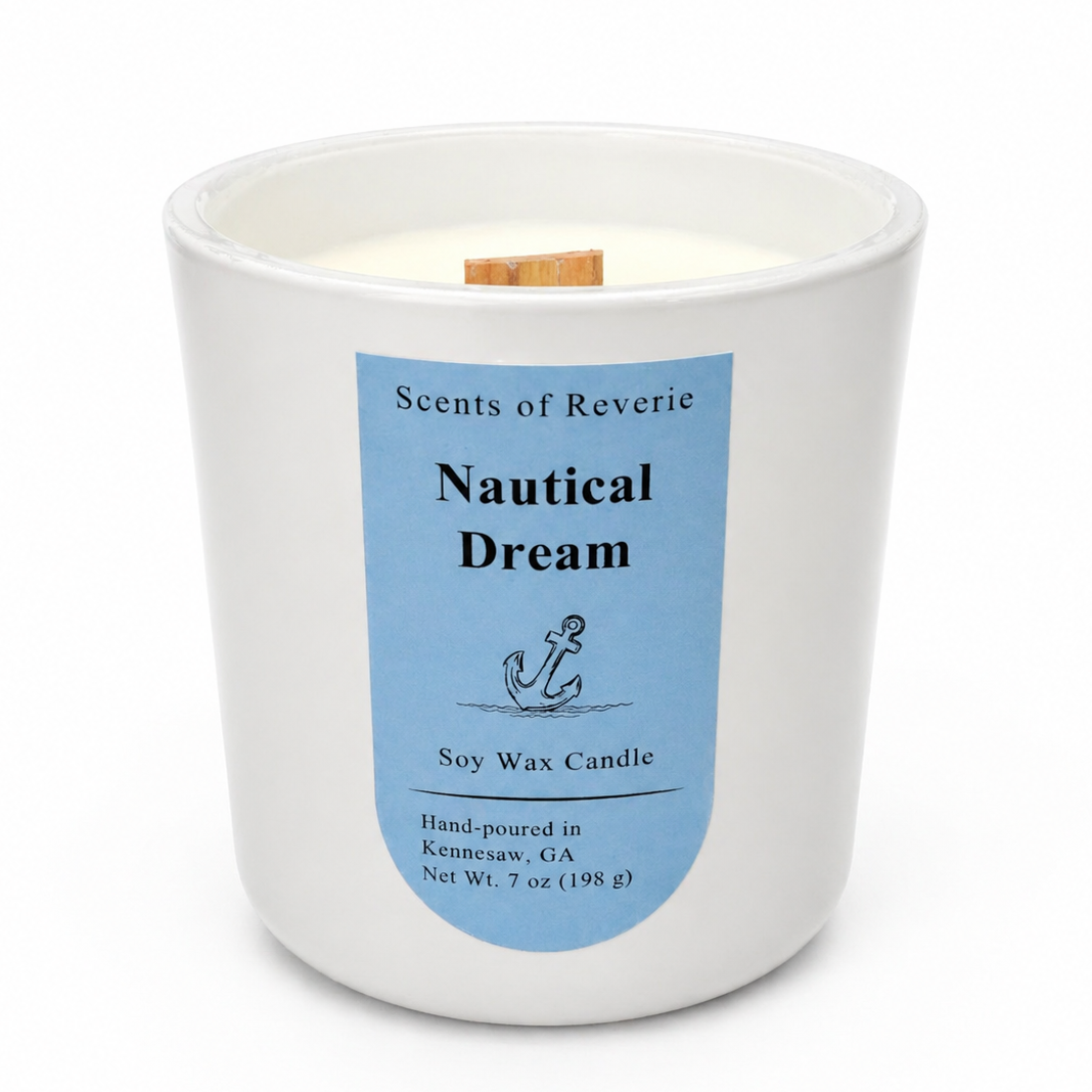 Candle with a blue label titled 'Nautical Dream' by Scents of Reverie on a white background.
